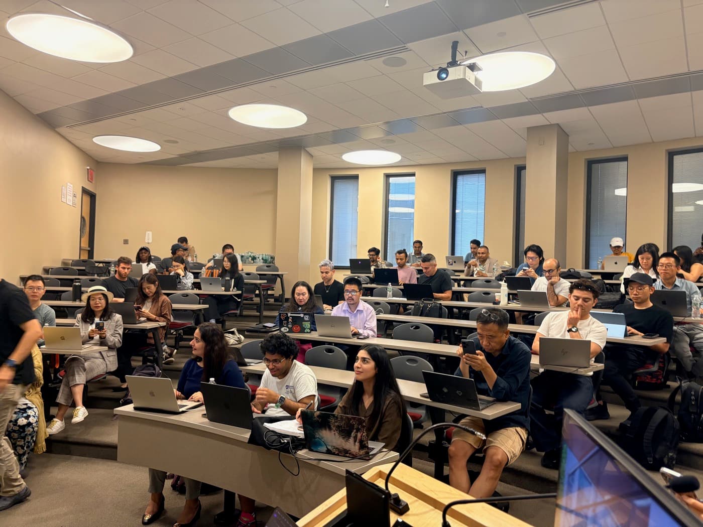 A full lecture hall at the MCP workshop, laptops open